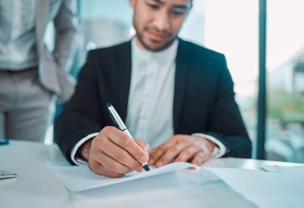 business owner signing a business partnership agreement