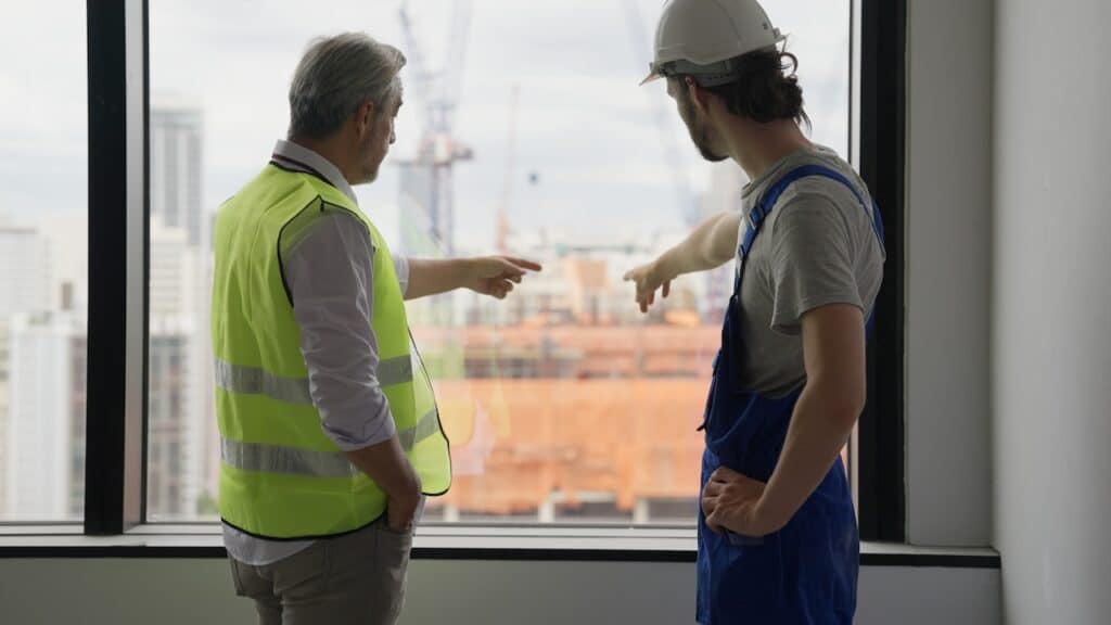 construction workers discussing construction defects